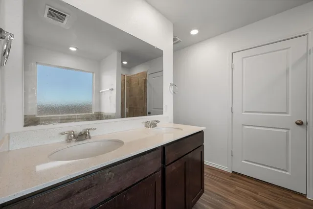 a bathroom with a sink double vanity and a mirror