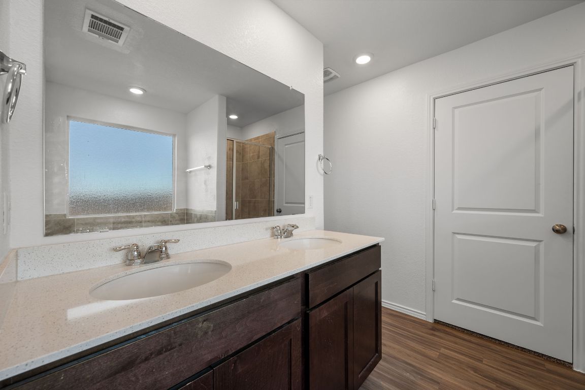 3206 Dusted Daisey Street Pflugerville, TX 78660 - Photo 13 of 25 a bathroom with a sink double vanity and a mirror
