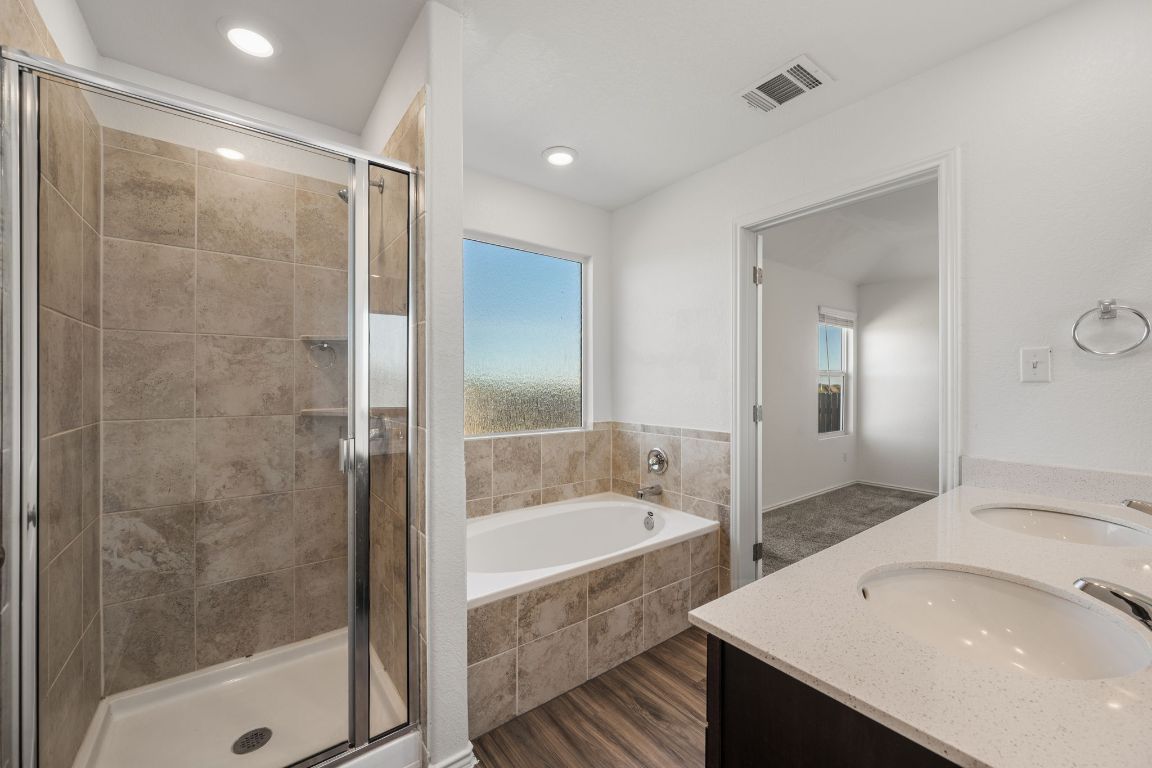 3206 Dusted Daisey Street Pflugerville, TX 78660 - Photo 14 of 25 a bathroom with a bathtub and a sink