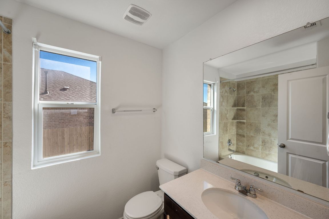 3206 Dusted Daisey Street Pflugerville, TX 78660 - Photo 17 of 25 a bathroom with a sink toilet and shower