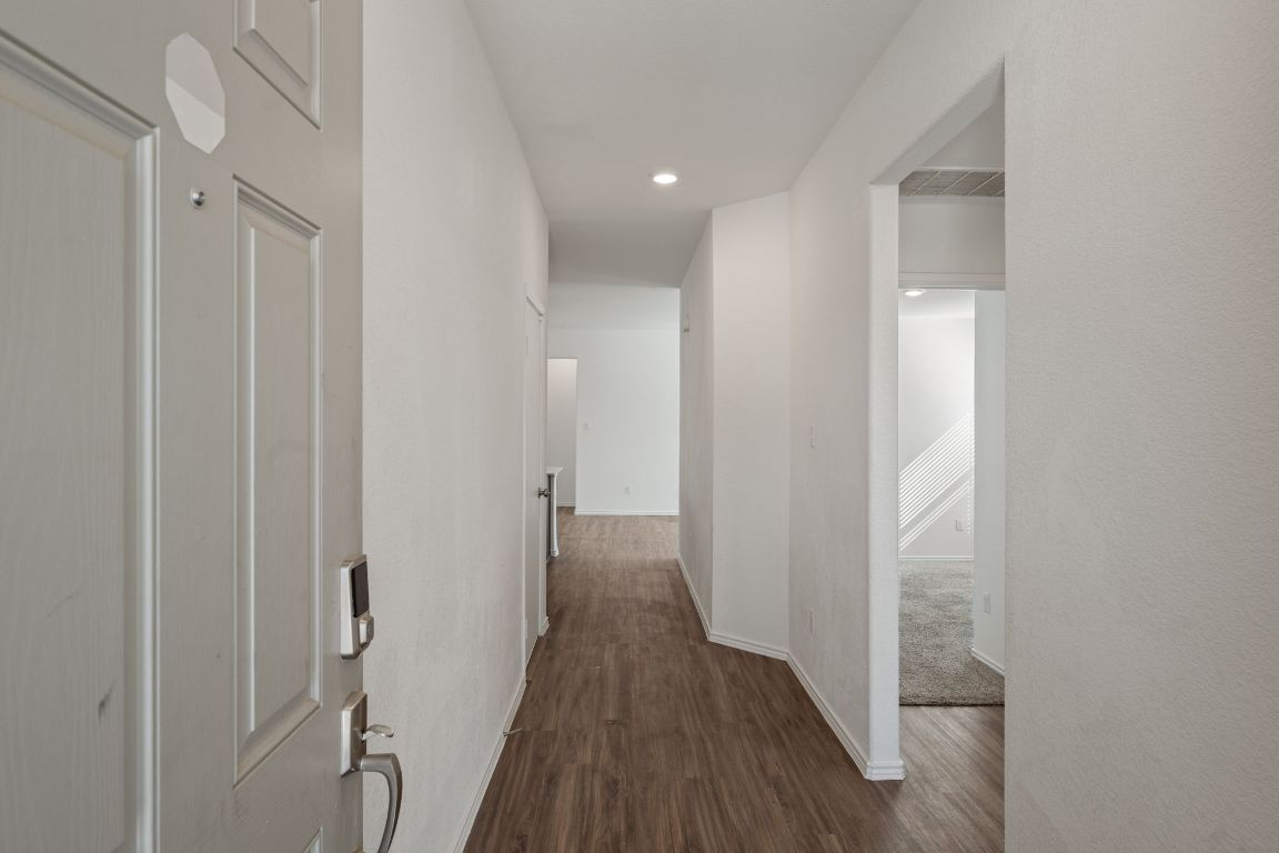 3206 Dusted Daisey Street Pflugerville, TX 78660 - Photo 3 of 25 a view of a hallway with wooden floor