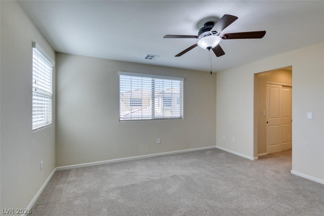 2549 Sable Ridge Street Henderson, NV 89044 - Photo 41 of 48 A well-lit bedroom featuring a ceiling fan and ample natural light from multiple windows.