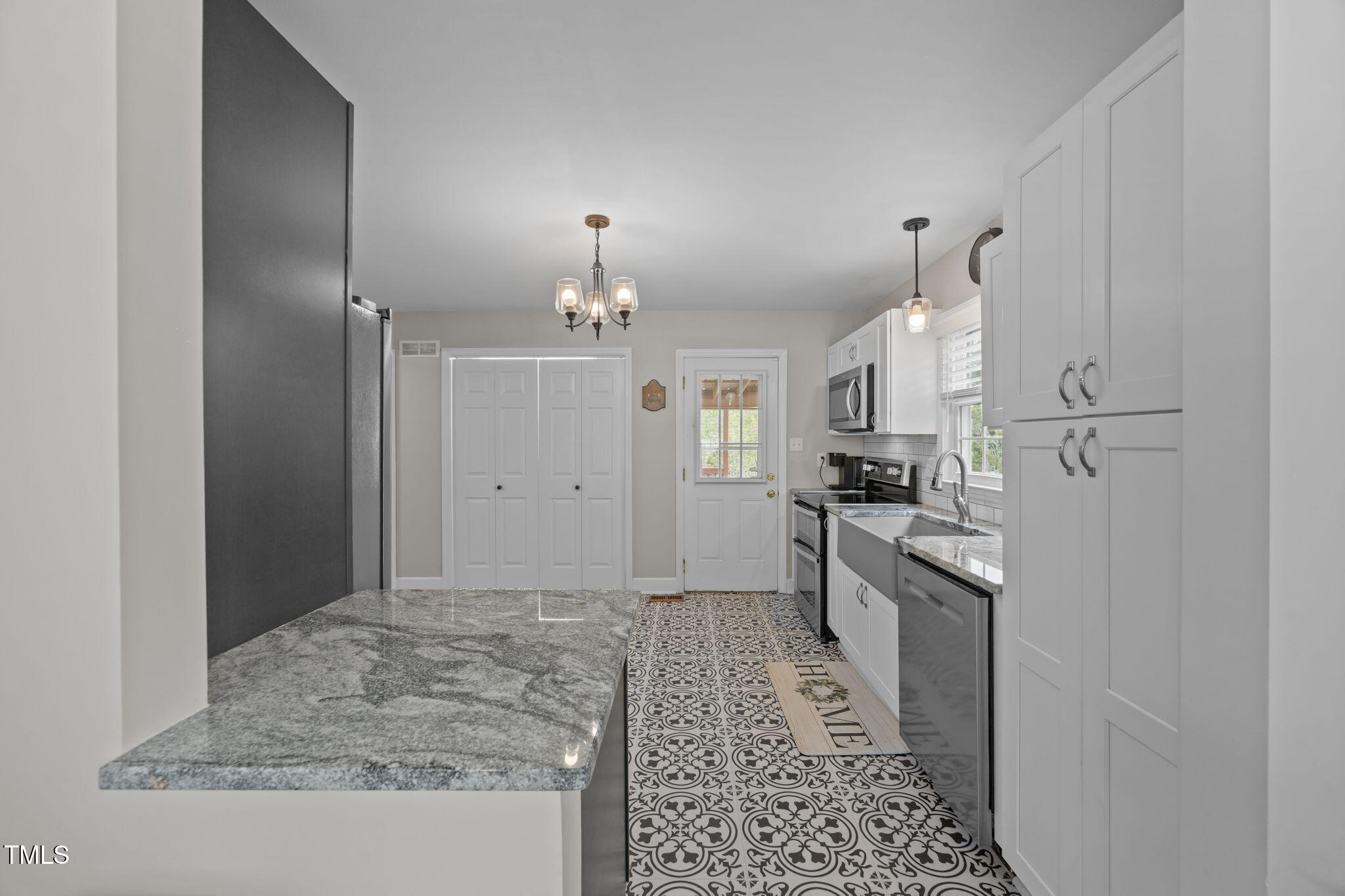 407 North 9th Street Mebane, NC 27302 - Photo 12 of 42 a kitchen with stainless steel appliances granite countertop a refrigerator and a sink