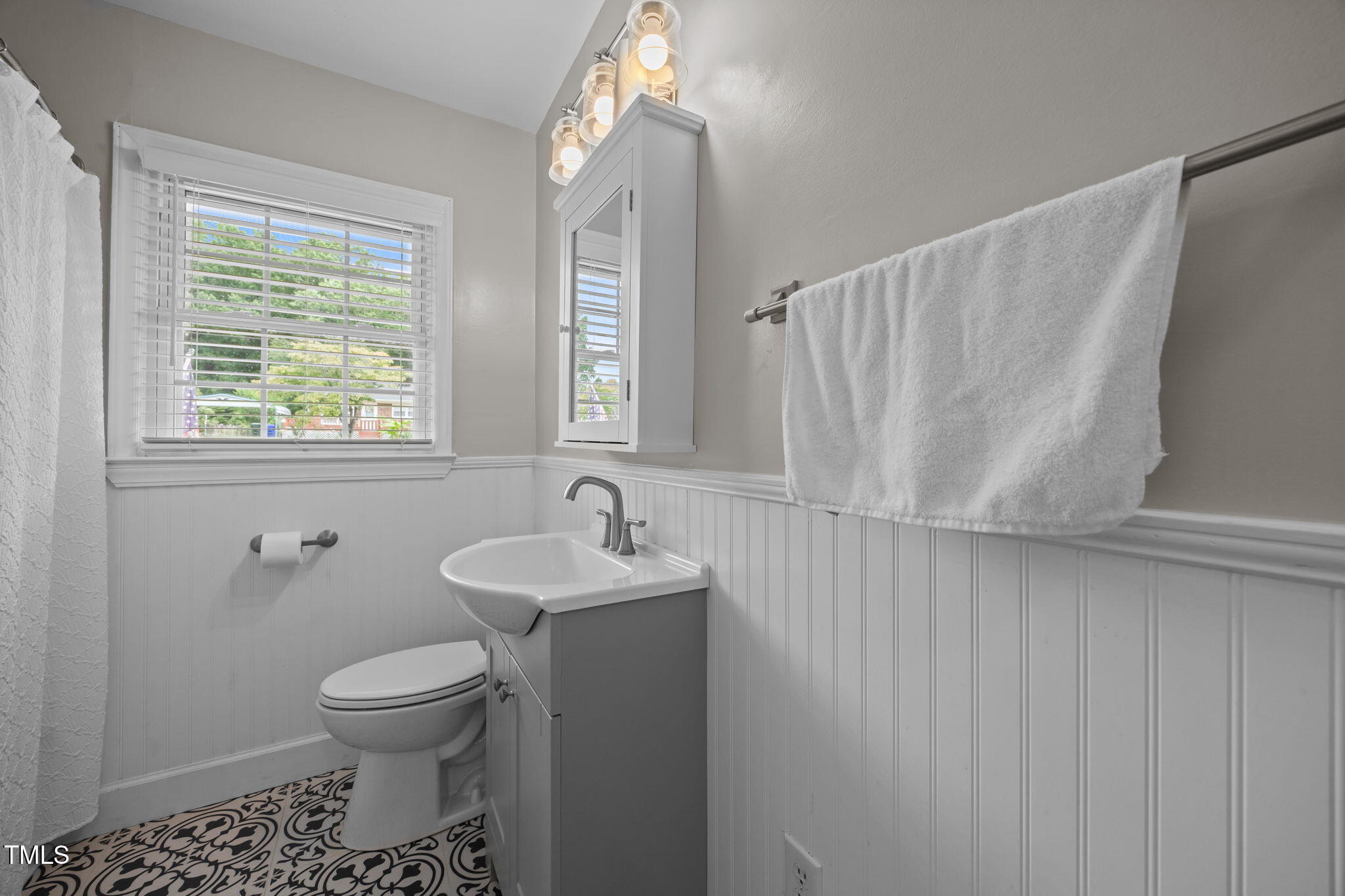 407 North 9th Street Mebane, NC 27302 - Photo 20 of 42 a bathroom with a toilet sink and mirror