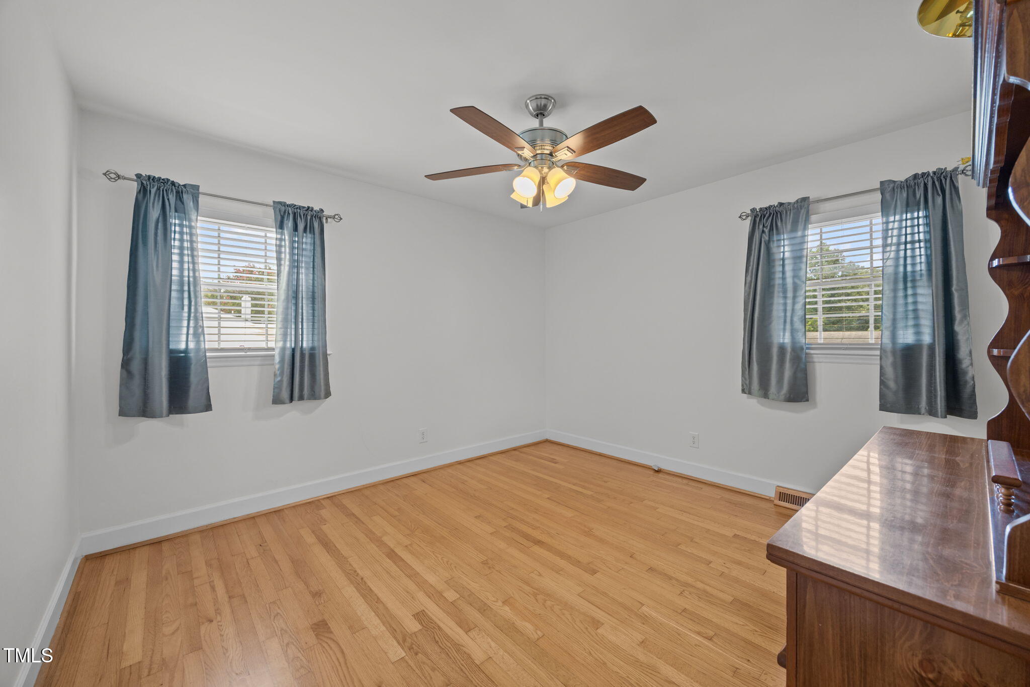 407 North 9th Street Mebane, NC 27302 - Photo 21 of 42 a view of an empty room with window and wooden floor