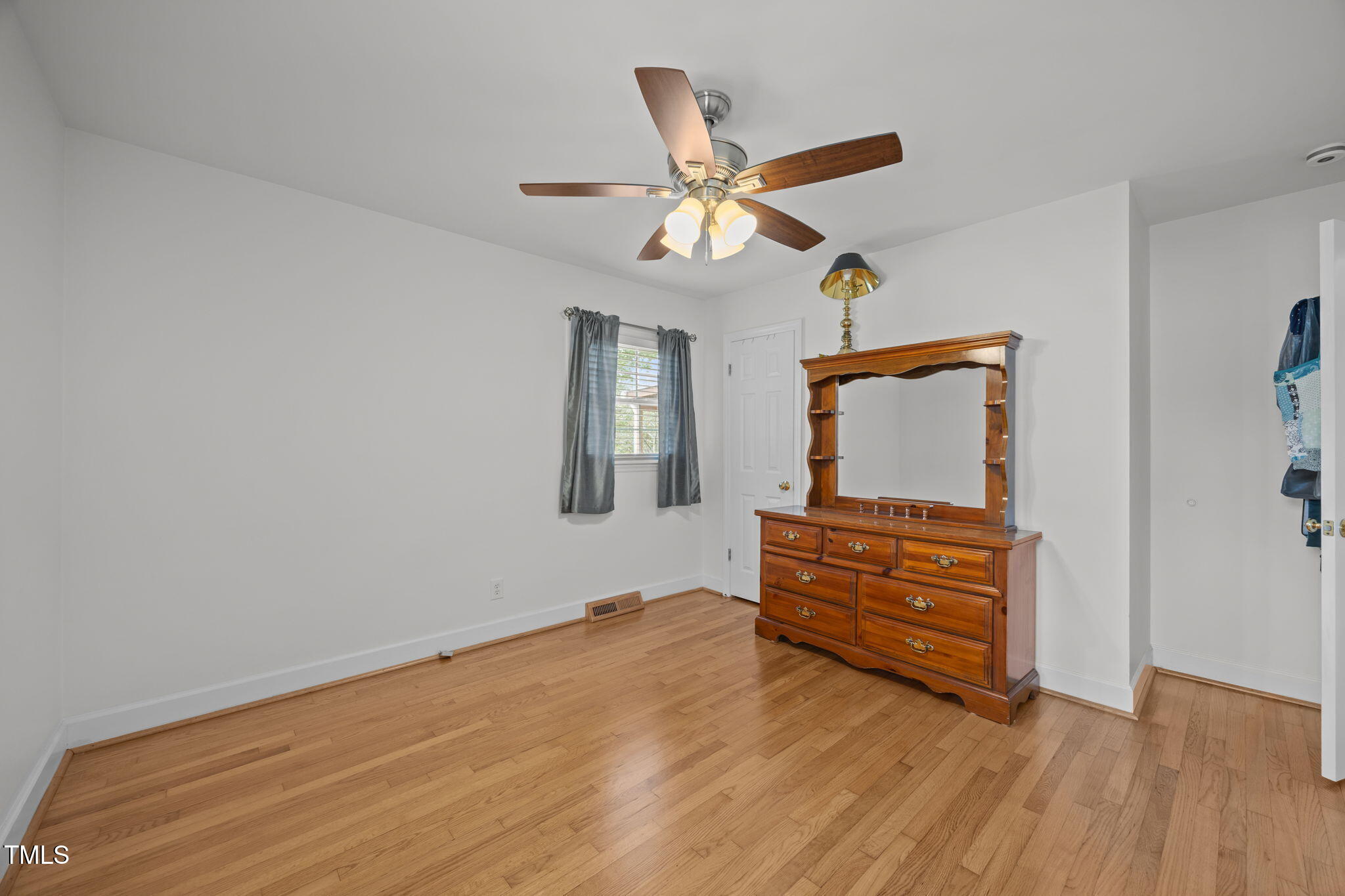 407 North 9th Street Mebane, NC 27302 - Photo 22 of 42 a room with wooden floor cabinet and a window