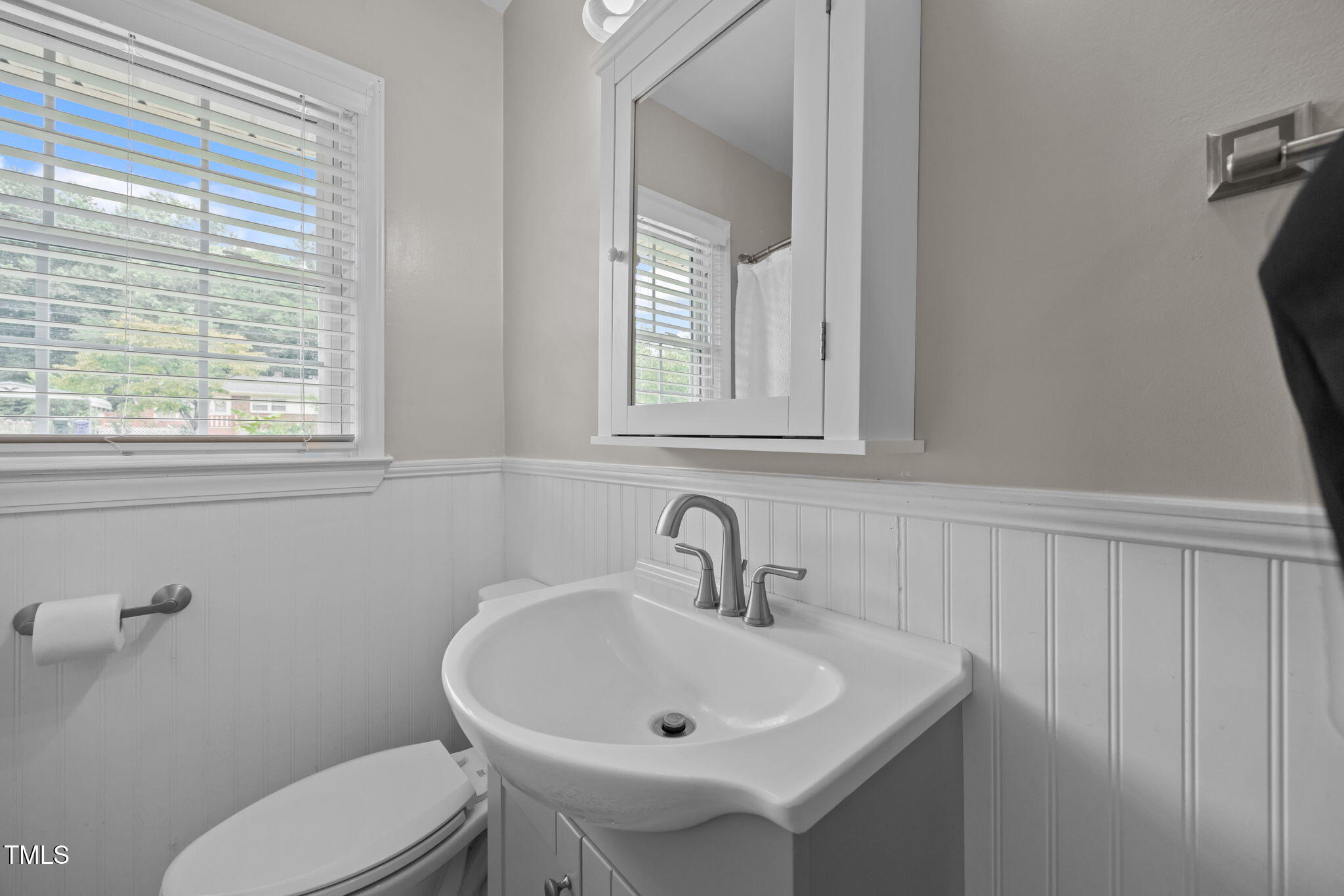 407 North 9th Street Mebane, NC 27302 - Photo 25 of 42 a bathroom with a toilet a sink and a window