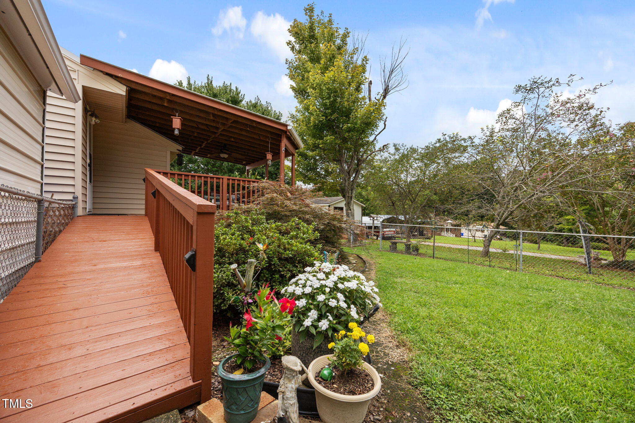 407 North 9th Street Mebane, NC 27302 - Photo 31 of 42 a backyard of a house with lots of green space and plants