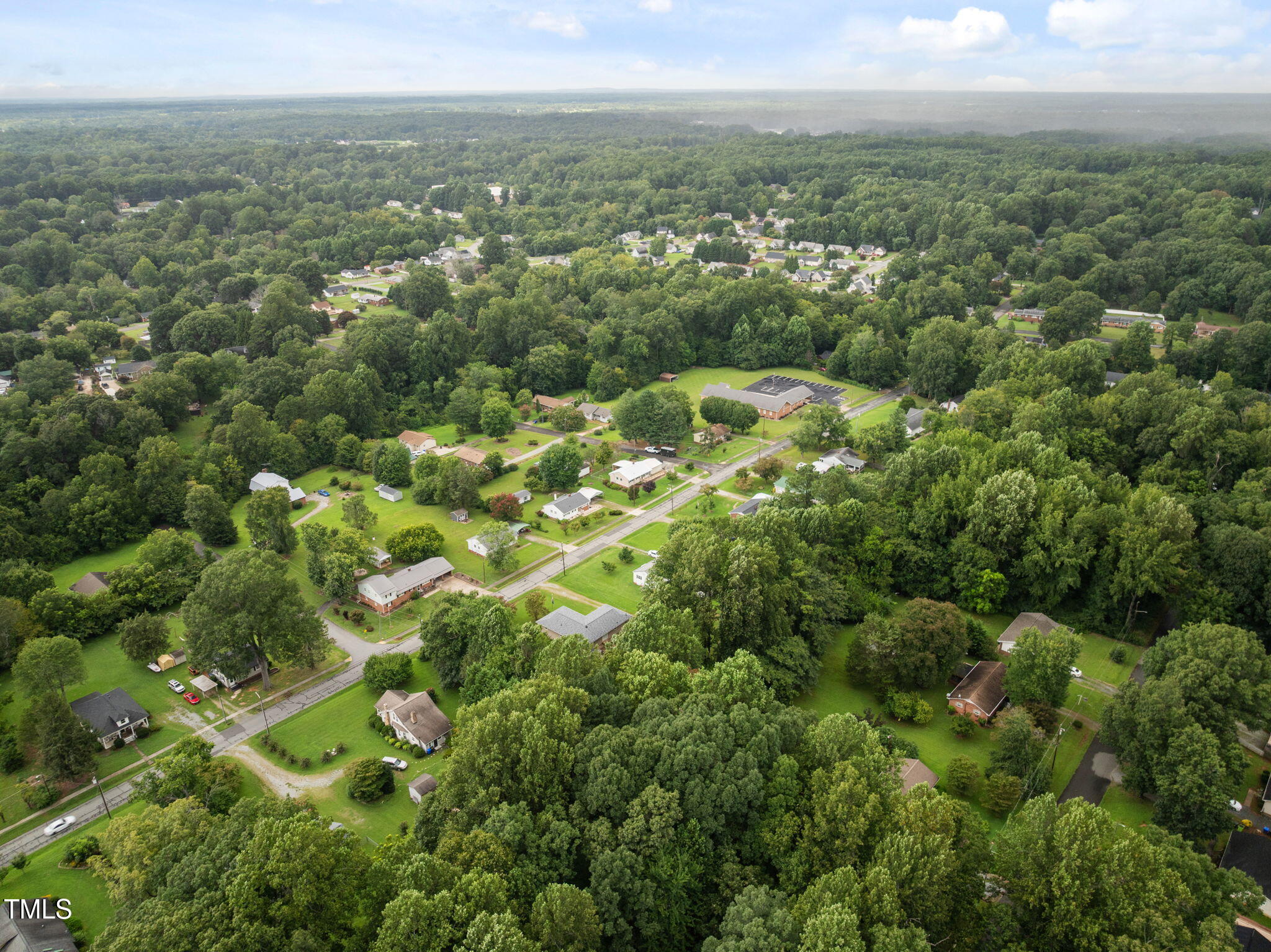 407 North 9th Street Mebane, NC 27302 - Photo 38 of 42 an aerial view of residential houses with outdoor space and trees