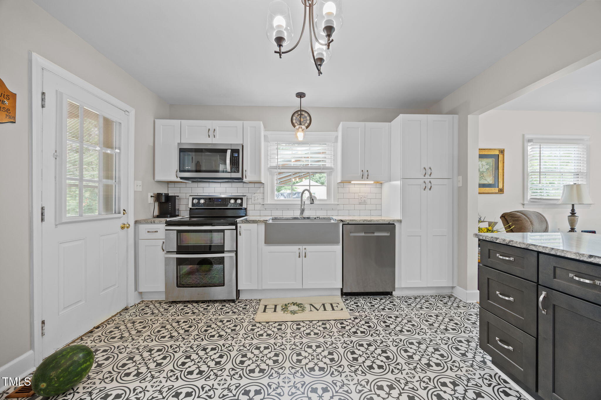 407 North 9th Street Mebane, NC 27302 - Photo 7 of 42 a kitchen with a refrigerator stove and microwave