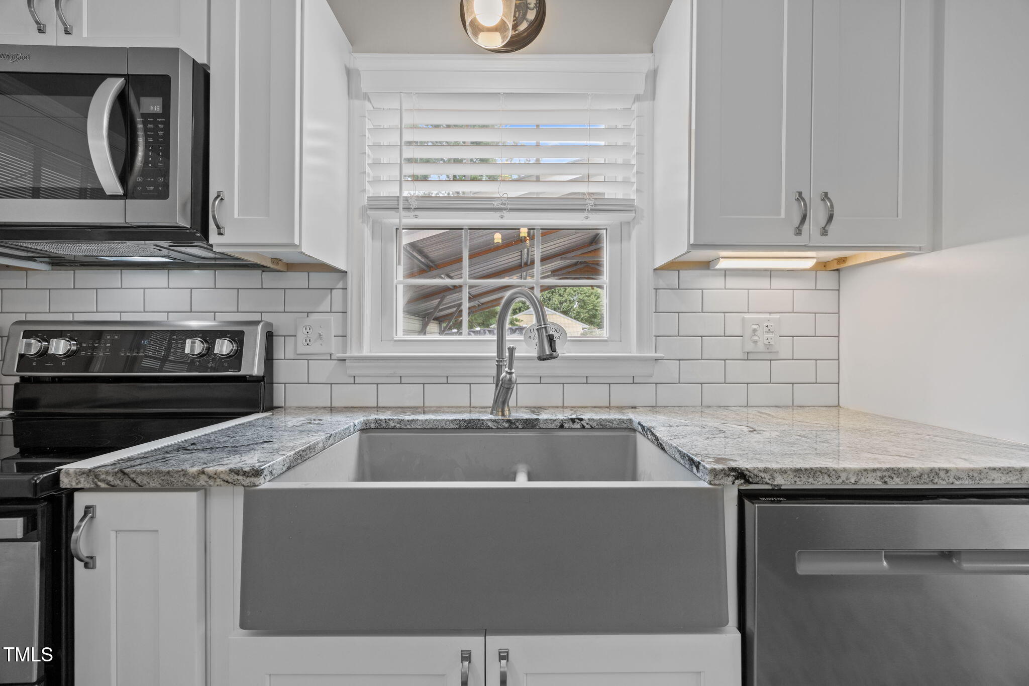 407 North 9th Street Mebane, NC 27302 - Photo 8 of 42 a kitchen with granite countertop a sink and a stove