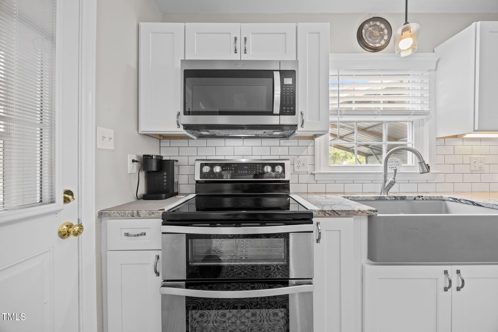 407 North 9th Street Mebane, NC 27302 - Photo 9 of 42 a kitchen with a stove and a microwave