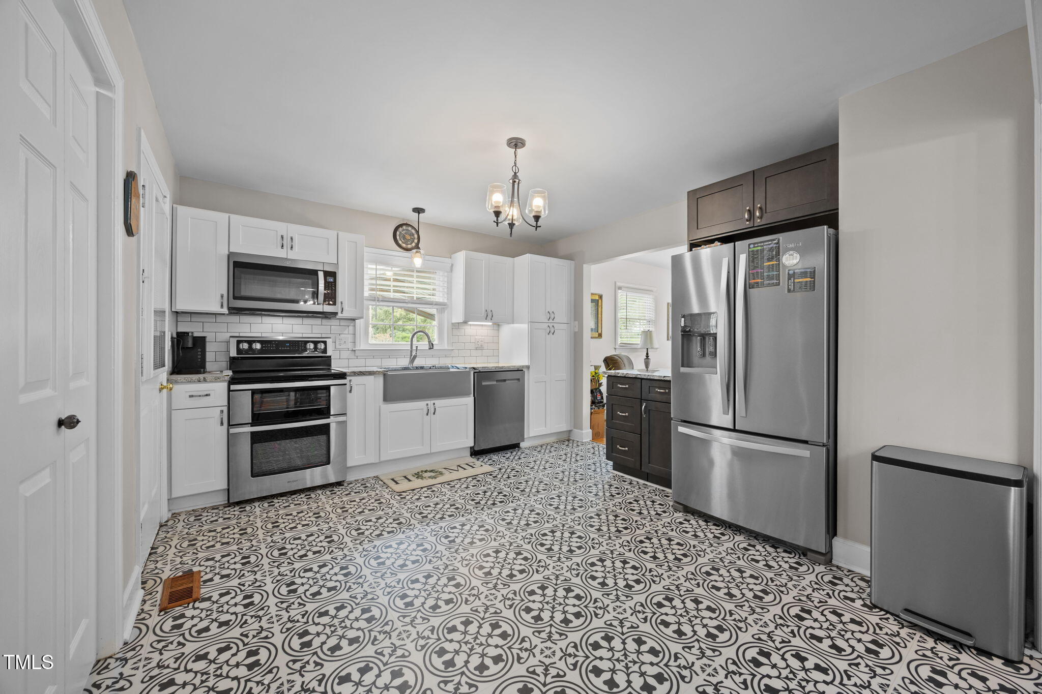 407 North 9th Street Mebane, NC 27302 - Photo 10 of 42 a kitchen with a refrigerator and a stove top oven