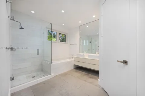 a bathroom with a bathtub and a shower