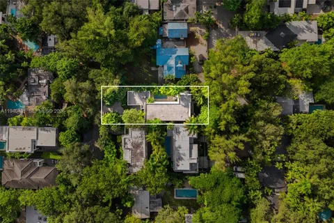 an aerial view of residential house with outdoor space and trees all around