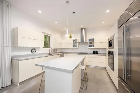 a kitchen with a sink a counter top stainless steel appliances and cabinets