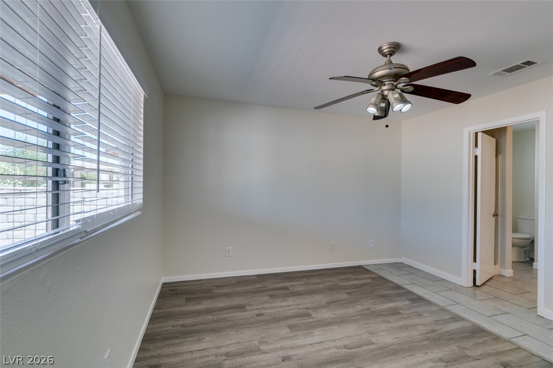 2028 Rustler Ridge Avenue North Las Vegas, NV 89031 - Photo 31 of 40 A quiet space for slumber featuring versatile flooring and a door opening to an adjacent washroom.