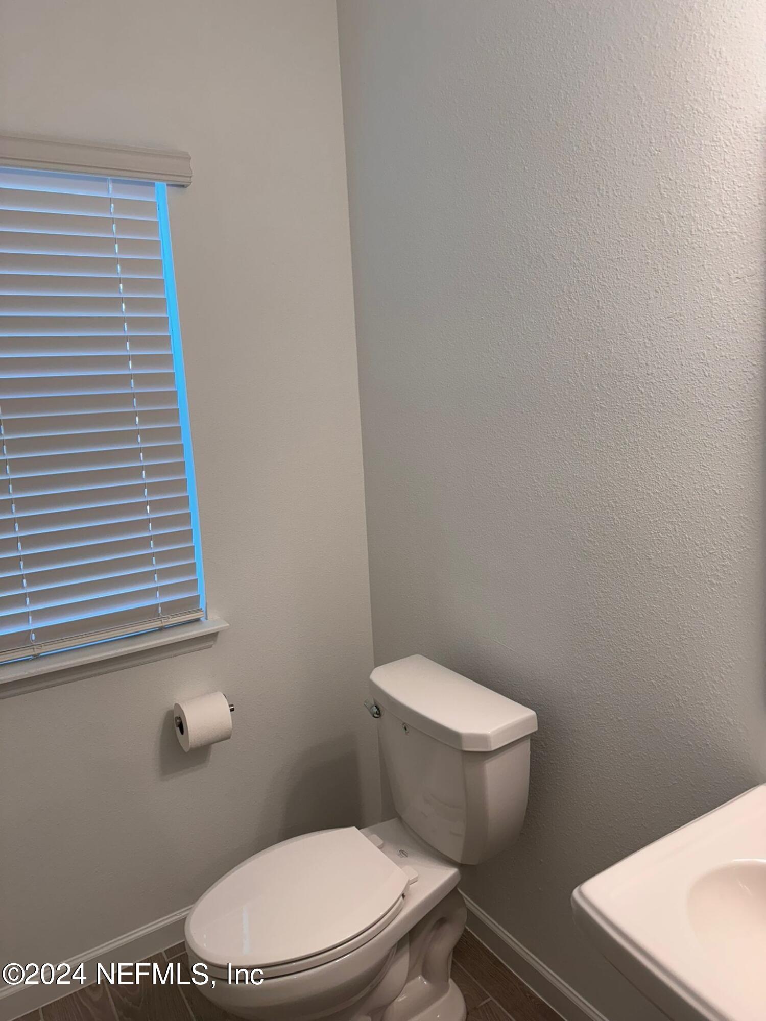 362 Belfort Court St. Augustine, FL 32092 - Photo 5 of 29 a white toilet sitting next to a small bathroom