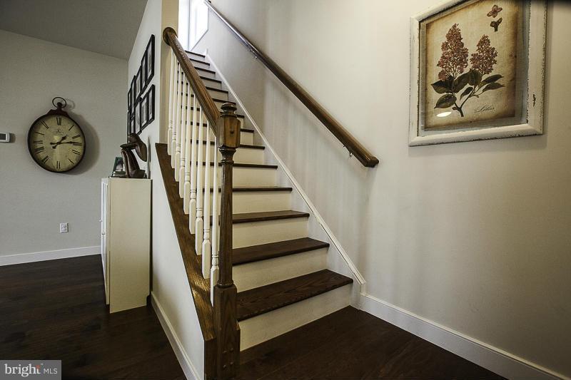 803 Sunken Road Fredericksburg, VA 22401 - Photo 12 of 23 a view of staircase with wooden floor and a table