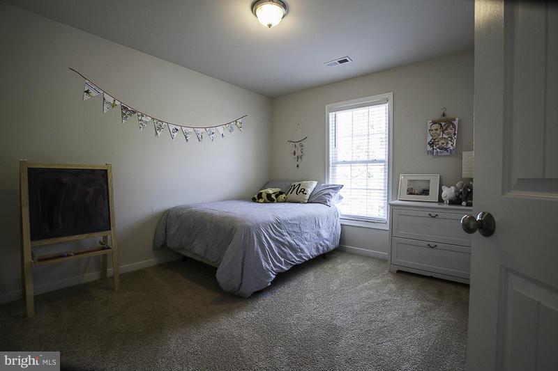 803 Sunken Road Fredericksburg, VA 22401 - Photo 21 of 23 a spacious bedroom with a bed and a window