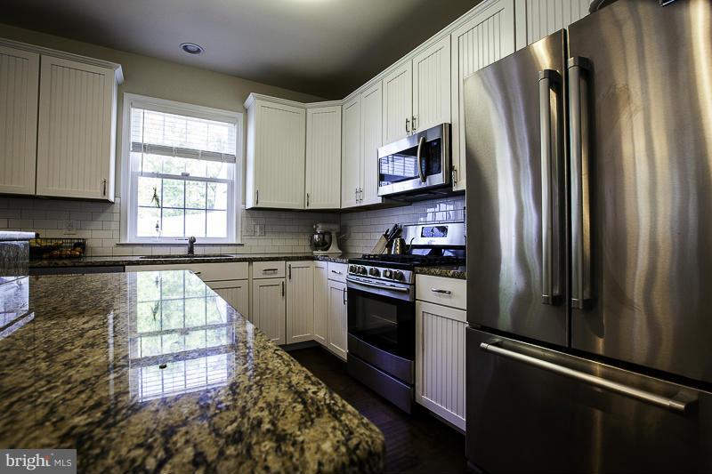 803 Sunken Road Fredericksburg, VA 22401 - Photo 8 of 23 a kitchen with granite countertop a refrigerator stove and microwave