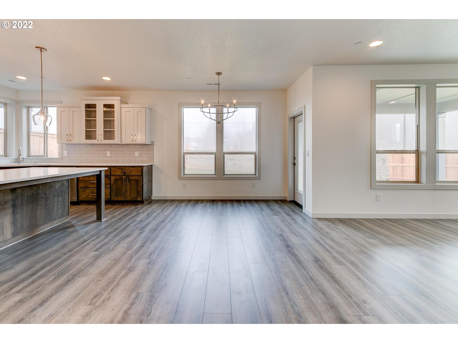 2512 South Cache Circle Ridgefield, WA 98642 - Photo 6 of 30 an empty room with wooden floor and windows