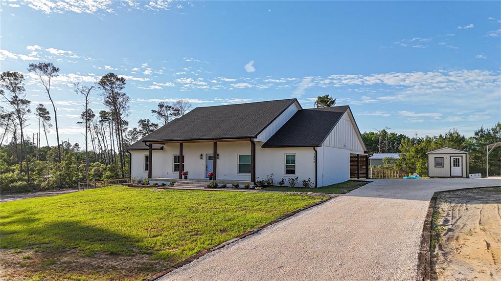 7890 Southwest 129th Avenue Cedar Key, FL 32625 - Photo 1 of 45 a front view of a house with garden