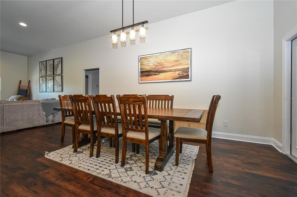 7890 Southwest 129th Avenue Cedar Key, FL 32625 - Photo 13 of 45 a view of a dining room with furniture and wooden floor