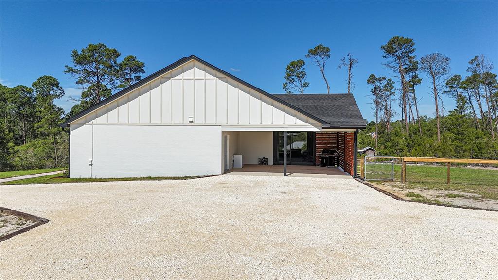 7890 Southwest 129th Avenue Cedar Key, FL 32625 - Photo 35 of 45 a view of a house with a backyard and garage