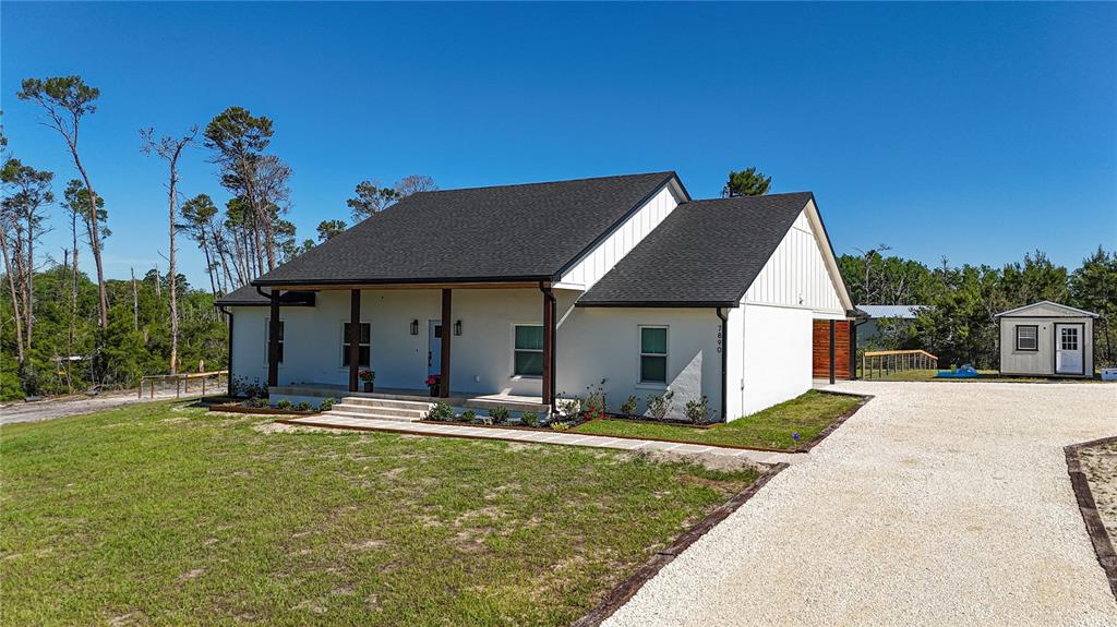 7890 Southwest 129th Avenue Cedar Key, FL 32625 - Photo 43 of 45 a front view of house with yard and trees in the background