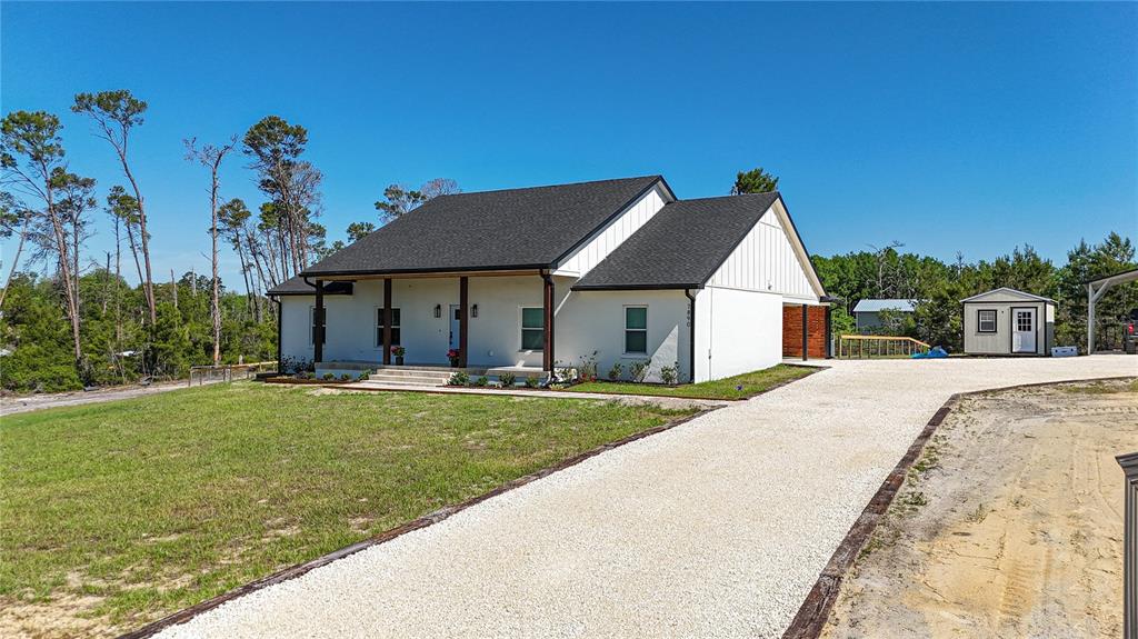 7890 Southwest 129th Avenue Cedar Key, FL 32625 - Photo 44 of 45 a front view of a house with garden