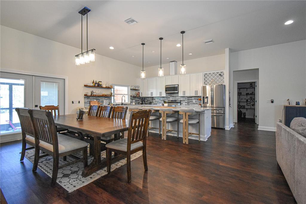 7890 Southwest 129th Avenue Cedar Key, FL 32625 - Photo 8 of 45 a view of a dining room and livingroom with furniture wooden floor a chandelier