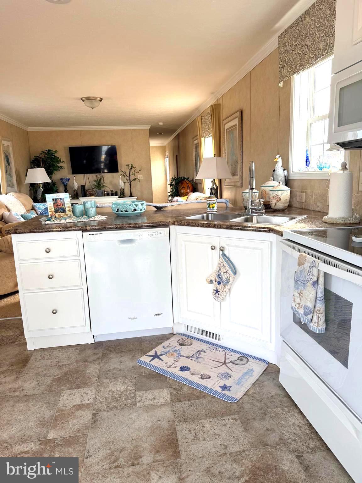 38025 Rabbit Road, Unit 101 Ocean View, DE 19970 - Photo 17 of 112 a kitchen with stainless steel appliances granite countertop a sink and cabinets