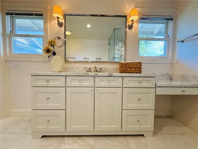 a bathroom with a sink a vanity and a mirror
