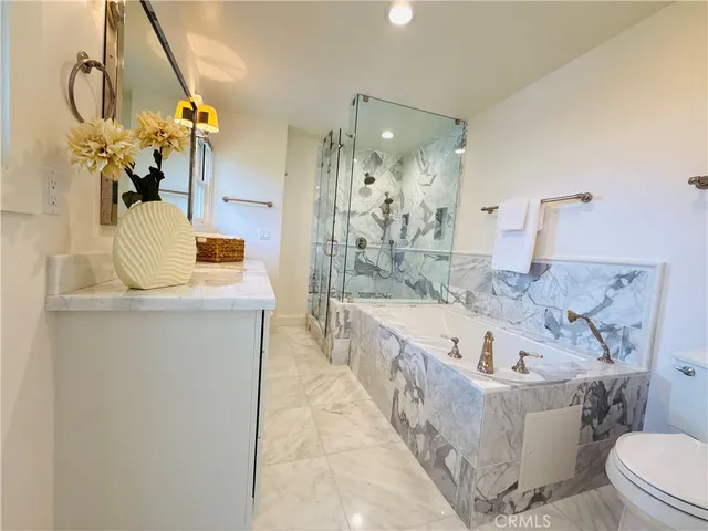 a bathroom with a tub sink and mirror