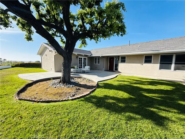 a swimming pool with outdoor seating and yard