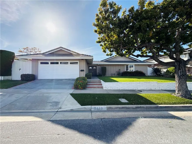 a front view of a house with yard and glass windows