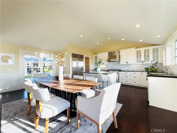 a large kitchen with a table and chairs