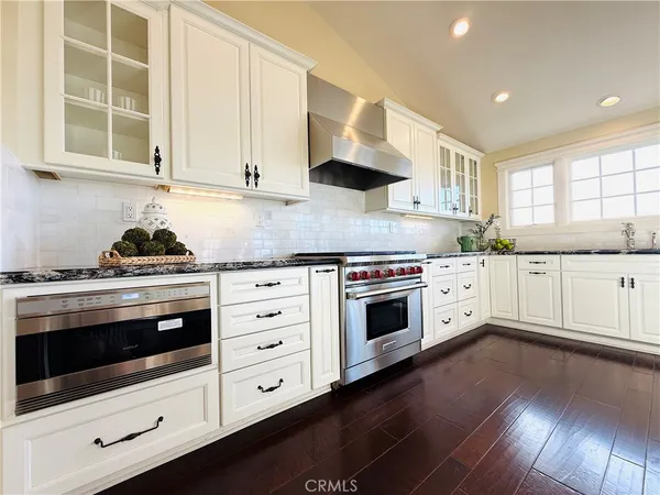a kitchen with stainless steel appliances a stove a sink and a microwave
