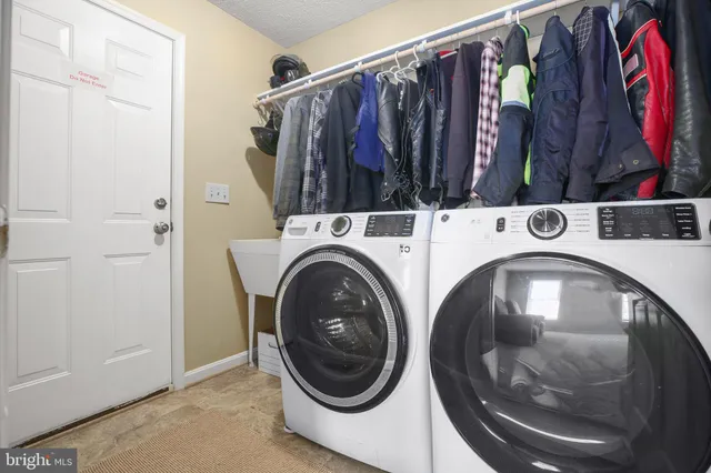 a bathroom with a granite countertop sink a toilet and a mirror