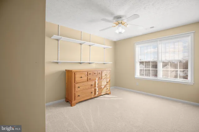 a bathroom with a sink a toilet and a large mirror