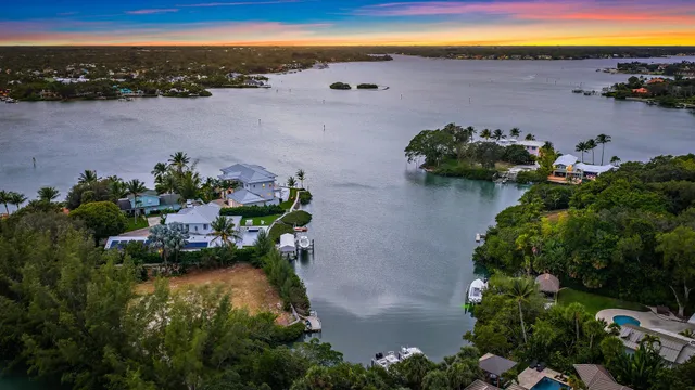 an aerial view of ocean with residential house with outdoor space