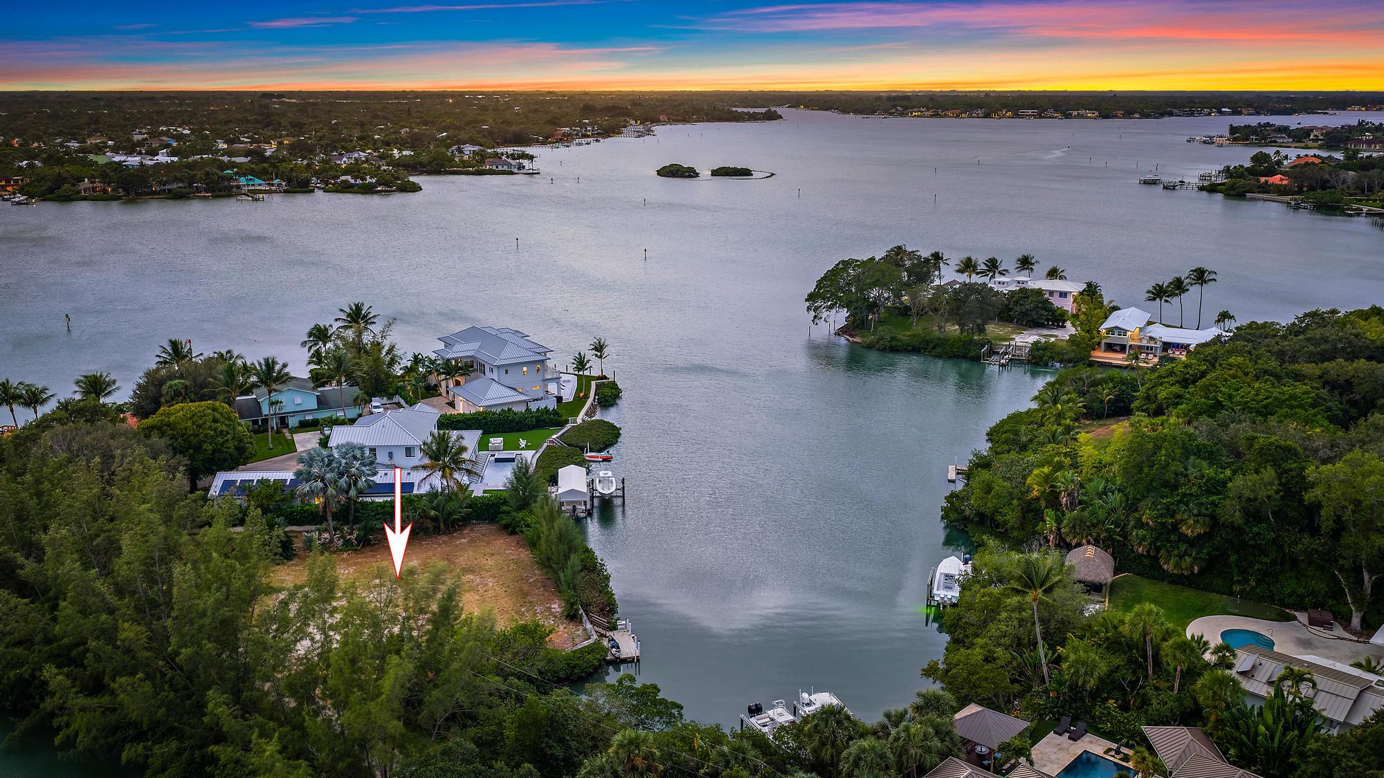 1310 Peninsular Road Jupiter, FL 33469 - Photo 9 of 17 an aerial view of a house with a garden and lake view