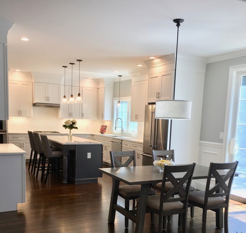 67 Evelyn Road Needham, MA 02494 - Photo 2 of 13 a large kitchen with a table and chairs