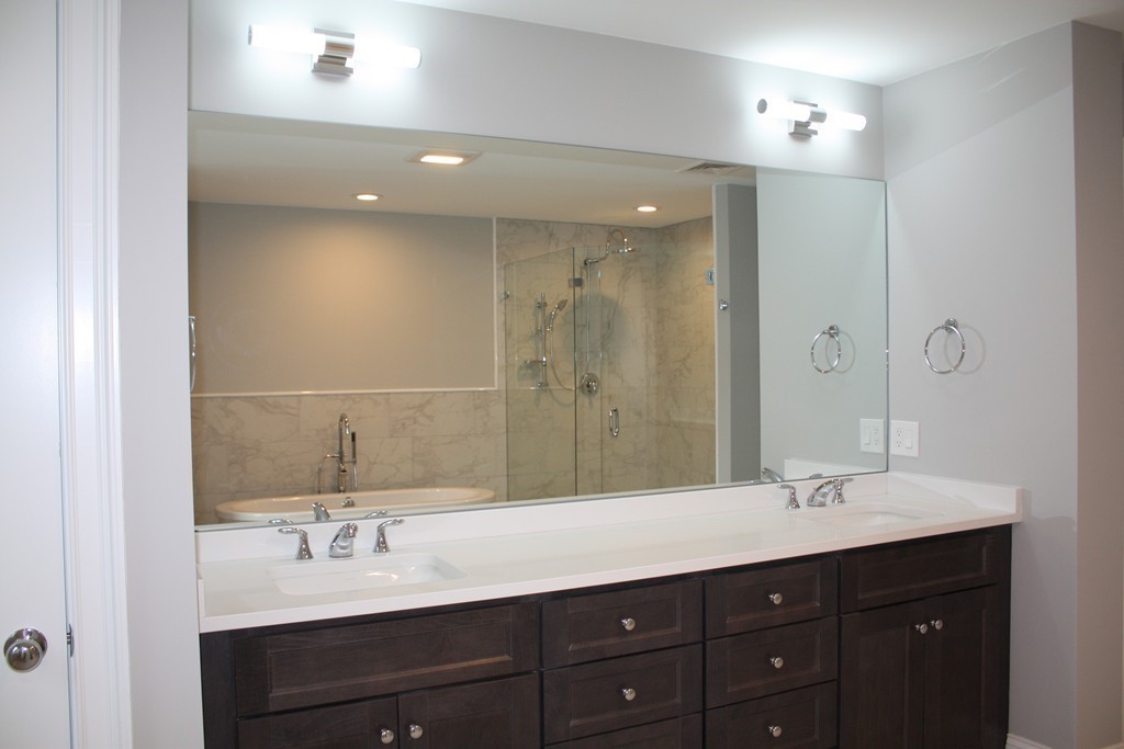 67 Evelyn Road Needham, MA 02494 - Photo 10 of 13 a bathroom with a sink double vanity and a mirror