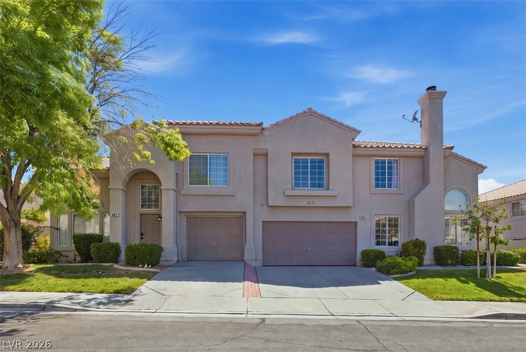 505 Rafkin Place Henderson, NV 89052 - Photo 1 of 35 A graceful two-story stucco residence presents an inviting arched entryway and dual garage doors.