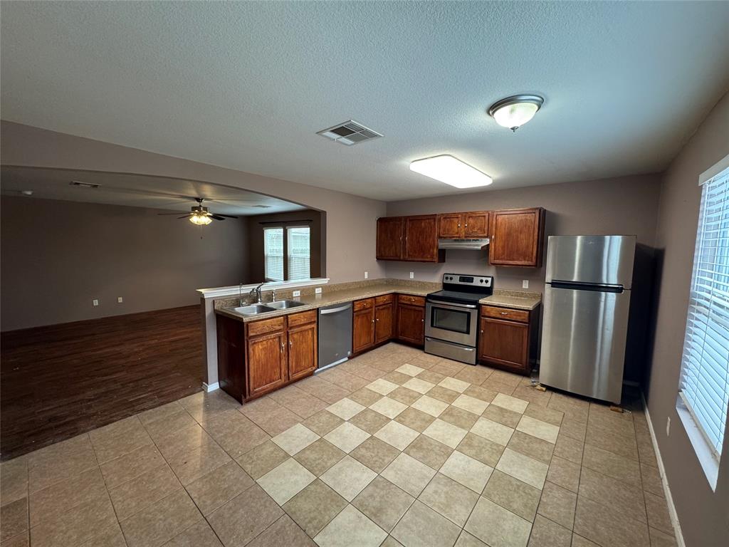 3200 Crownover Street Austin, TX 78725 - Photo 5 of 23 A well-appointed kitchen features stainless steel appliances and an inviting open-concept layout.