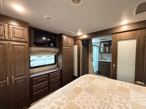 a bedroom with a bed and a television