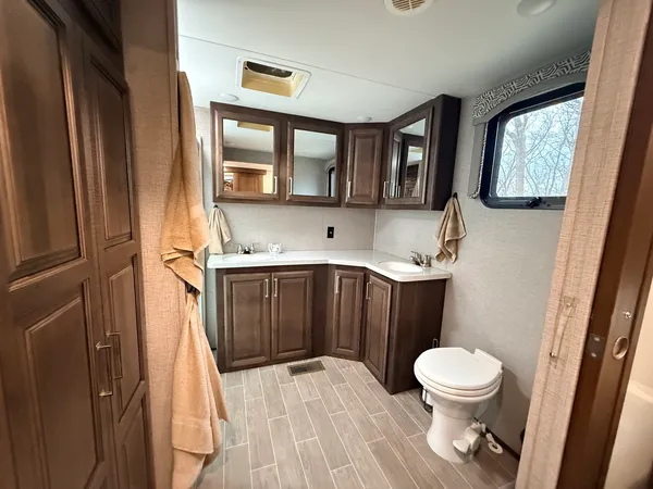 a bathroom with a toilet a sink and mirror