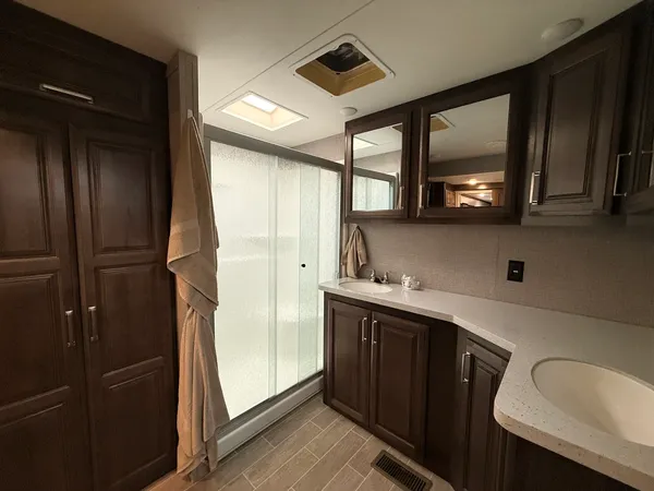 a bathroom with a sink a toilet and mirror